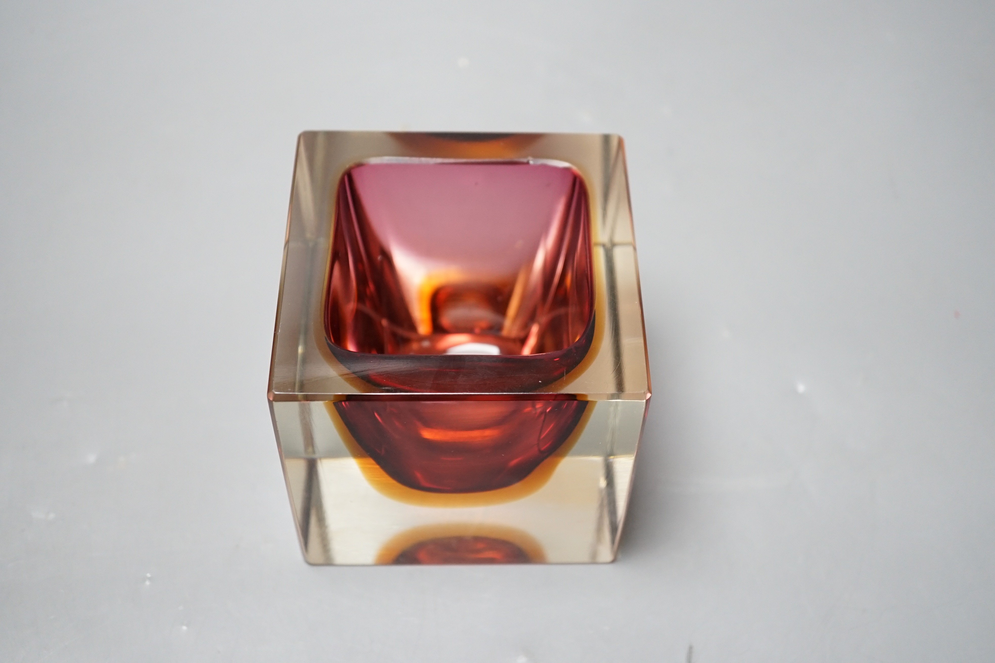 A Murano red, amber and clear cased glass cube vase, 9.5cm tall